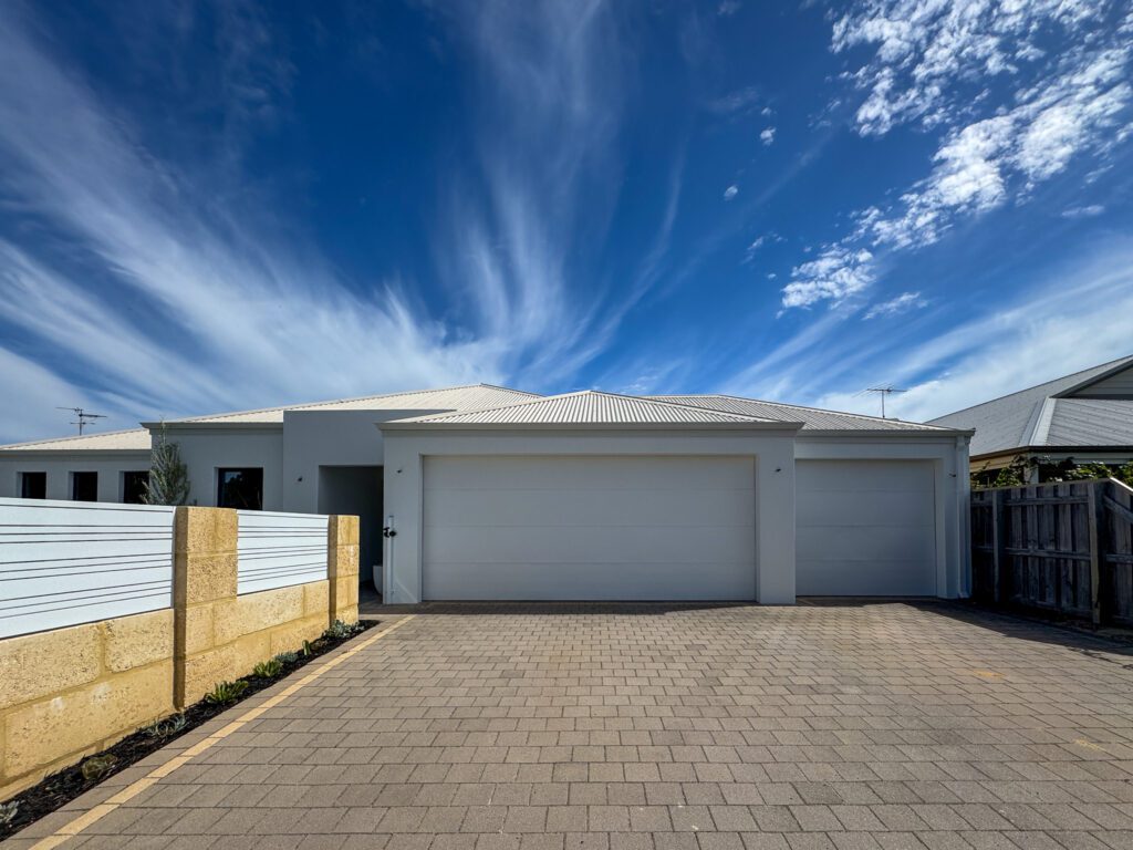 Mandurah home with garage door and exterior walls painted in Dulux Snowy Mountains Half for a modern, unified facade